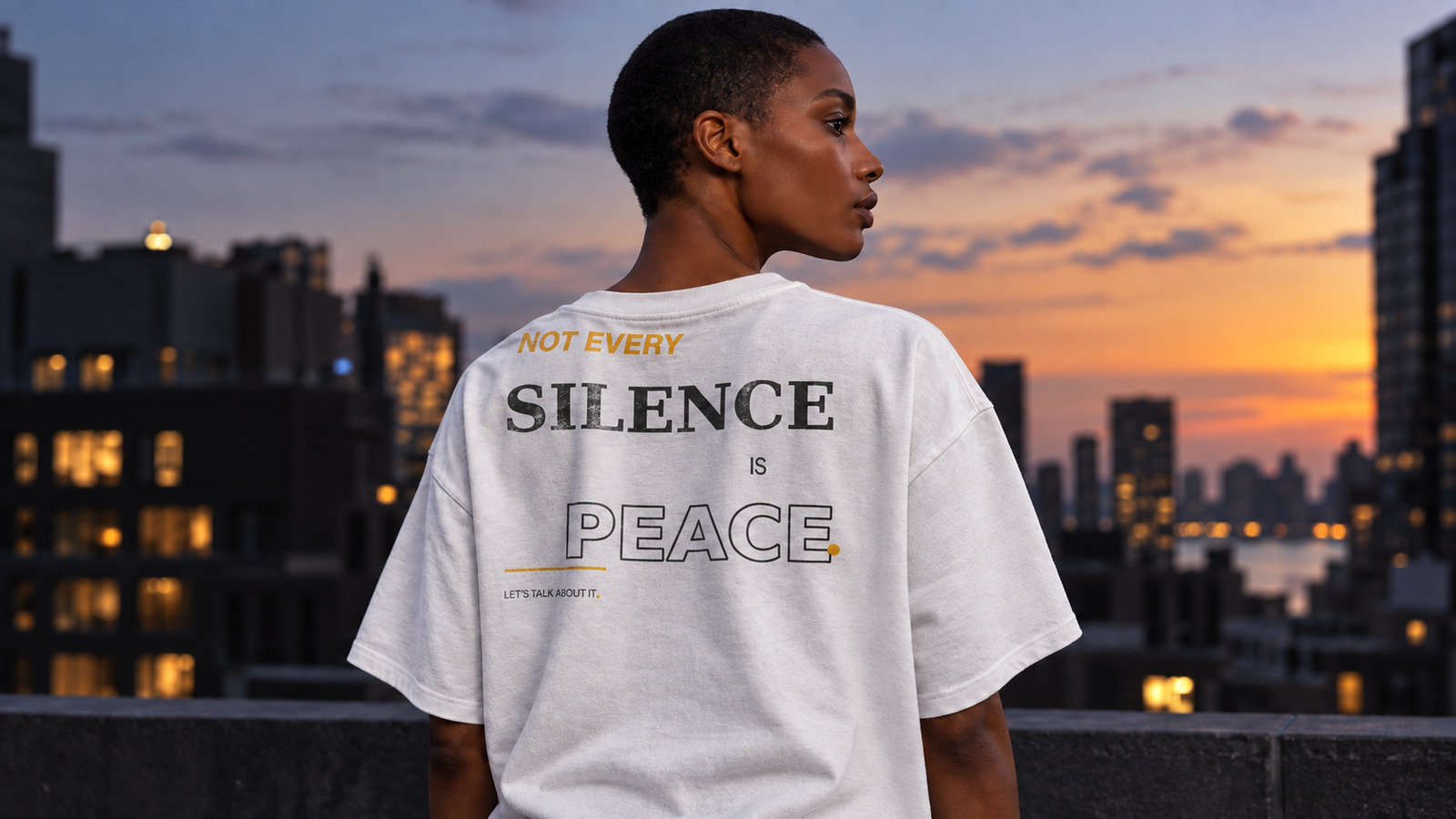 Black model wearing the Not Every Silence Is Peace statement tee in White