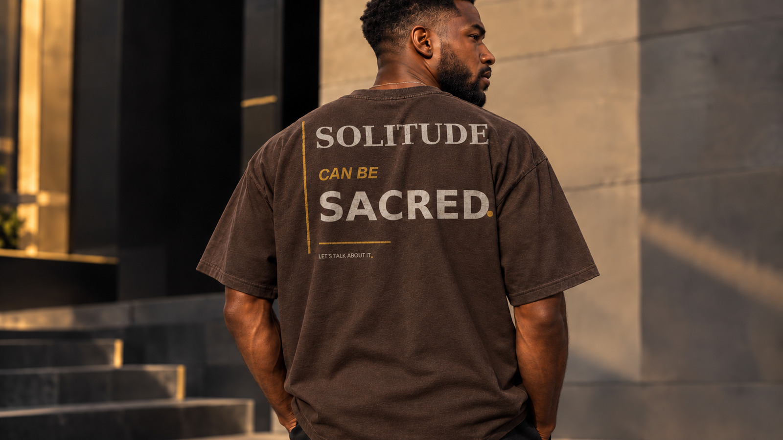 Black model wearing the Solitude Can Be Sacred statement tee in Espresso