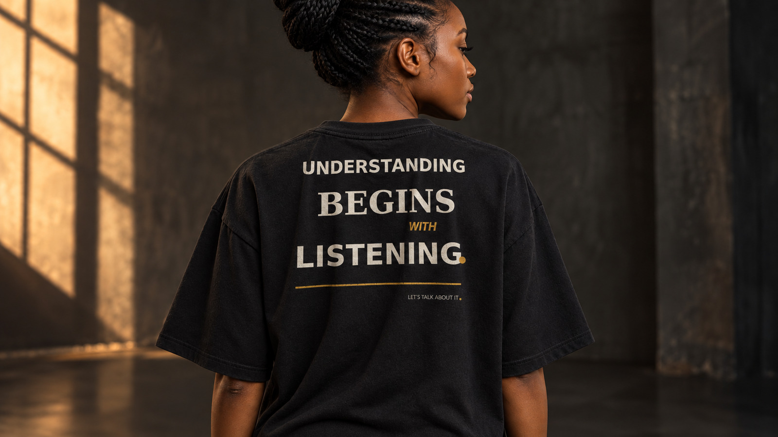 Black model wearing the Understanding Begins With Listening statement tee in Black